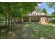 Expansive backyard with mature trees and a covered patio at 4446 Lakeridge Dr, Indianapolis, IN 46234