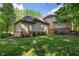 Spacious backyard surrounded by lush greenery and mature trees at 4446 Lakeridge Dr, Indianapolis, IN 46234