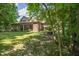 Wide backyard view with a covered patio and mature tree border at 4446 Lakeridge Dr, Indianapolis, IN 46234
