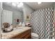 Updated bathroom features granite countertops and geometric shower curtain at 4446 Lakeridge Dr, Indianapolis, IN 46234