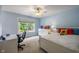 Comfortable bedroom with bright blue walls, white furniture, and a ceiling fan at 4446 Lakeridge Dr, Indianapolis, IN 46234