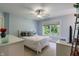 Light and airy bedroom with large window, ceiling fan, and bright blue walls at 4446 Lakeridge Dr, Indianapolis, IN 46234