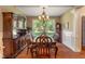 Formal dining room with hardwood floors, large window with backyard view, and elegant furniture at 4446 Lakeridge Dr, Indianapolis, IN 46234