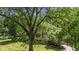 Charming stone and brick house with a well-manicured lawn and mature trees creating a private setting at 4446 Lakeridge Dr, Indianapolis, IN 46234