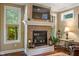 Attractive stone fireplace provides a focal point between two large windows overlooking a wooded area at 4446 Lakeridge Dr, Indianapolis, IN 46234