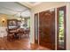 Welcoming foyer featuring hardwood floors, a decorative dark wood front door, and dining room view at 4446 Lakeridge Dr, Indianapolis, IN 46234