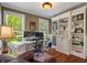 Well-lit home office with large windows, custom bookshelves, and a comfortable workspace at 4446 Lakeridge Dr, Indianapolis, IN 46234