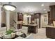 Modern kitchen boasts dark wood cabinetry, granite counters, stainless appliances and an eat-in area at 4446 Lakeridge Dr, Indianapolis, IN 46234