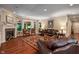 Inviting living room boasts a fireplace, rich hardwood floors, and a comfortable leather sofa at 4446 Lakeridge Dr, Indianapolis, IN 46234