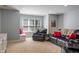 Cozy living room with plush carpeting, a comfortable leather sofa, and bright natural light at 4446 Lakeridge Dr, Indianapolis, IN 46234
