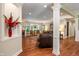 Open-concept living room featuring hardwood floors, a fireplace, large windows, and comfortable seating at 4446 Lakeridge Dr, Indianapolis, IN 46234