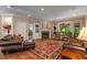 Cozy living room with fireplace, plush leather seating, and lots of natural light from large windows at 4446 Lakeridge Dr, Indianapolis, IN 46234
