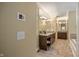 Hallway view into primary bathroom includes vanity with granite counters and a seated makeup area at 4446 Lakeridge Dr, Indianapolis, IN 46234