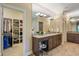 A luxurious vanity with a large mirror, and a walk-in closet, in the primary bathroom area at 4446 Lakeridge Dr, Indianapolis, IN 46234