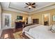 Large primary bedroom features wood floors, a ceiling fan, access to a private balcony, and en suite bathroom at 4446 Lakeridge Dr, Indianapolis, IN 46234