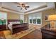 Spacious main bedroom with trey ceiling, fan, wood floors, and large windows for ample natural light at 4446 Lakeridge Dr, Indianapolis, IN 46234