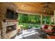 Relaxing covered patio includes fireplace and open view to backyard at 4446 Lakeridge Dr, Indianapolis, IN 46234
