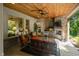 Cozy patio with stone fireplace, wood ceiling, and comfortable seating at 4446 Lakeridge Dr, Indianapolis, IN 46234