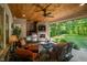 Inviting covered patio featuring a fireplace, TV, and outdoor kitchen at 4446 Lakeridge Dr, Indianapolis, IN 46234