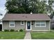 Charming single-story home featuring a well-maintained lawn, inviting entryway and a classic, neutral color scheme at 4761 Payton Ave, Lawrence, IN 46226