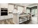 Modern kitchen with white cabinets, stainless steel appliances, and a breakfast bar with seating at 5002 Jasper Ridge Blvd, Indianapolis, IN 46235