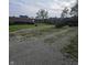 Gravel driveway and backyard area with sheds and garages at 509 S E St, Arcadia, IN 46030