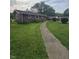 A cozy single-story home with a chimney, complemented by lush green grass and a concrete walkway at 509 S E St, Arcadia, IN 46030