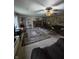 Spacious living room with a fireplace, ceiling fan, and large patterned area rug at 509 S E St, Arcadia, IN 46030