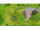 Aerial view of the home showcasing the expansive lot, mature trees, and detached garage at 5550 W Mooresville Rd Byp, Indianapolis, IN 46221