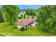 A beautiful ranch style home with stone facade and mature trees on a well maintained lawn at 5550 W Mooresville Rd Byp, Indianapolis, IN 46221