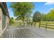 Spacious backyard features a deck with railing and view to trees and blue skies at 5550 W Mooresville Rd Byp, Indianapolis, IN 46221
