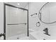 Modern bathroom features new vanity, toilet, mirror, and a tiled shower with glass door at 5550 W Mooresville Rd Byp, Indianapolis, IN 46221