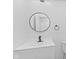 Modern bathroom features a round mirror, white vanity, and black hardware at 5550 W Mooresville Rd Byp, Indianapolis, IN 46221