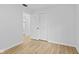 A bright bedroom with wood floor and large closet, adjacent to bath at 5550 W Mooresville Rd Byp, Indianapolis, IN 46221