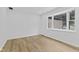 Bright bedroom with a large window and wood floor at 5550 W Mooresville Rd Byp, Indianapolis, IN 46221