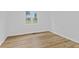 A bright bedroom with wood floor, window and light walls at 5550 W Mooresville Rd Byp, Indianapolis, IN 46221
