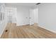 Bright bedroom features light wood flooring, white walls, a bathroom and two closets at 5550 W Mooresville Rd Byp, Indianapolis, IN 46221