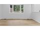 Bright bedroom featuring a large bay window and modern wood floor at 5550 W Mooresville Rd Byp, Indianapolis, IN 46221