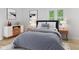 Beautiful bedroom features a stylish bed, modern nightstands and mountain-themed art at 5550 W Mooresville Rd Byp, Indianapolis, IN 46221