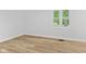 Bright bedroom features light wood flooring, white walls and a window with natural outdoor view at 5550 W Mooresville Rd Byp, Indianapolis, IN 46221
