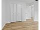 Bedroom featuring wood floors and a large closet with an adjacent doorway at 5550 W Mooresville Rd Byp, Indianapolis, IN 46221