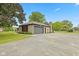Well-maintained stone home with a two-car garage and a spacious driveway at 5550 W Mooresville Rd Byp, Indianapolis, IN 46221