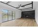 Inviting living room with a stone fireplace, ceiling fan, and sliding glass doors to the backyard at 5550 W Mooresville Rd Byp, Indianapolis, IN 46221