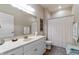 Well-lit bathroom featuring a single sink vanity with white cabinets and vinyl flooring at 564 Parkhurst Ct, Greenwood, IN 46142