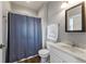 Bathroom featuring wood-look floors, single sink vanity, and shower-tub combo with a blue curtain at 564 Parkhurst Ct, Greenwood, IN 46142