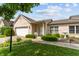 Inviting single-story brick home with lush landscaping and a cozy front porch at 564 Parkhurst Ct, Greenwood, IN 46142
