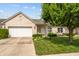 Charming single-story brick home with a well-manicured lawn and attached two-car garage at 564 Parkhurst Ct, Greenwood, IN 46142