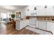 Functional kitchen featuring white cabinets, laminate countertops, and an open layout at 564 Parkhurst Ct, Greenwood, IN 46142