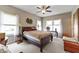 Well lit main bedroom with neutral carpet, windows with sheer curtains, and a ceiling fan at 564 Parkhurst Ct, Greenwood, IN 46142