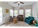 Cozy sunroom featuring a ceiling fan, lots of natural light, and a view of the neighborhood at 564 Parkhurst Ct, Greenwood, IN 46142